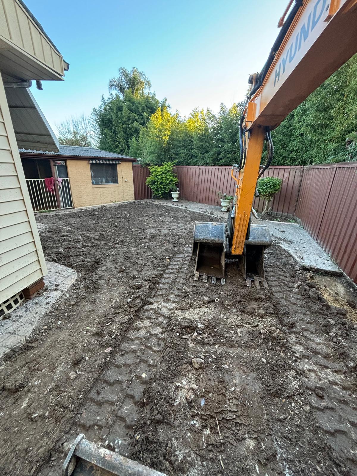 Backfilled and levelled pool site after excavation and spoil removal