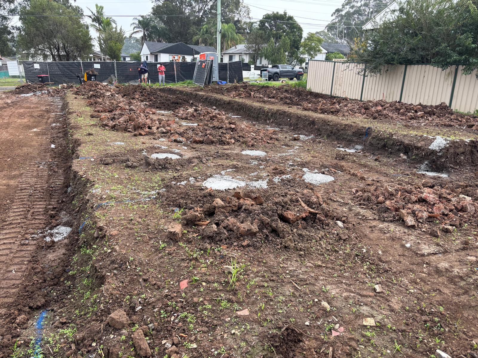 Site cut in progress on a southwest Sydney residential block, freshly excavated pad with battered edges