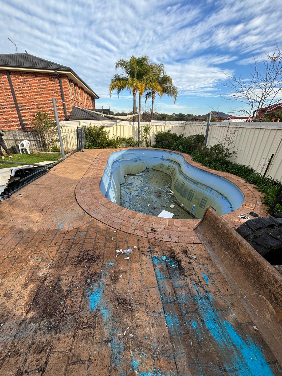 Older fibreglass pool shell prepped for removal on a southwest Sydney property